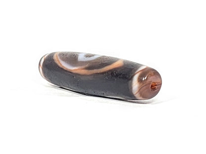 Ac-030525-3E right drill hole end, warm reddish-brown end cap and interior, pitch-black body, unretouched