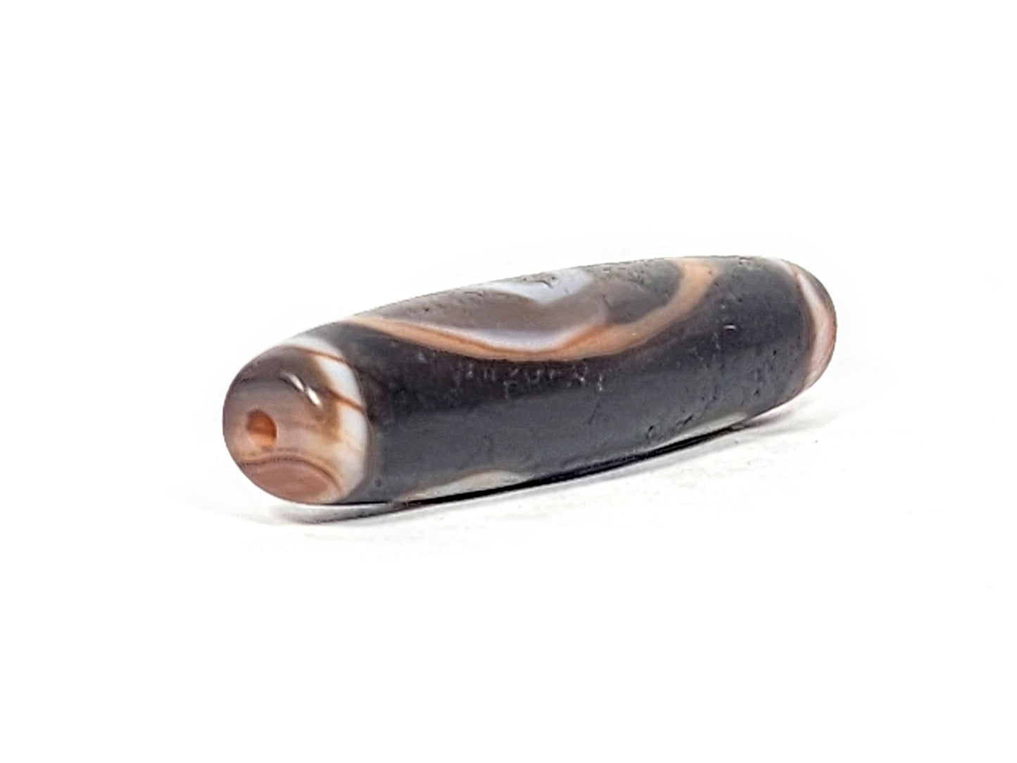 Ac-030525-3E left drill hole end, warm terracotta-orange interior, chocolate-brown end cap, body micro-texture, unretouched