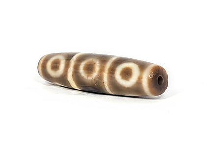 Ac-071026-8E ancient eight eye dzi angled view drill end A warm reddish-brown end cap small clean hole unretouched