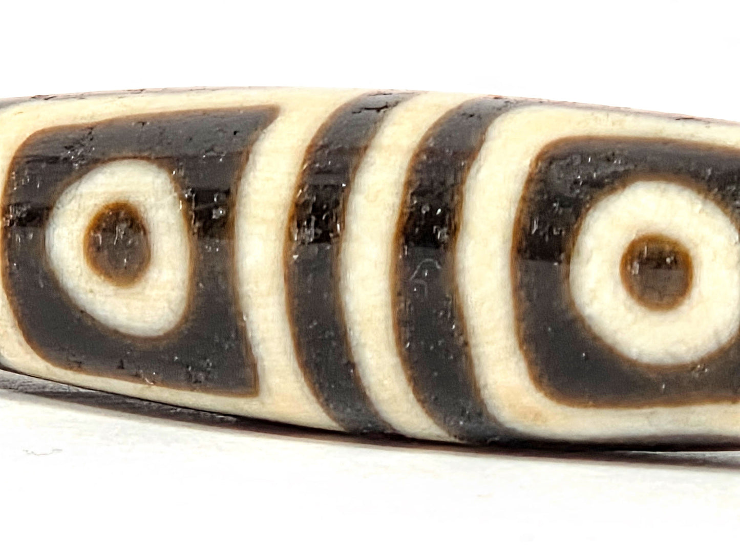 Ac-080425-4E macro Face A, both square-framed eyes full detail, surface pit between eyes disclosed, unretouched