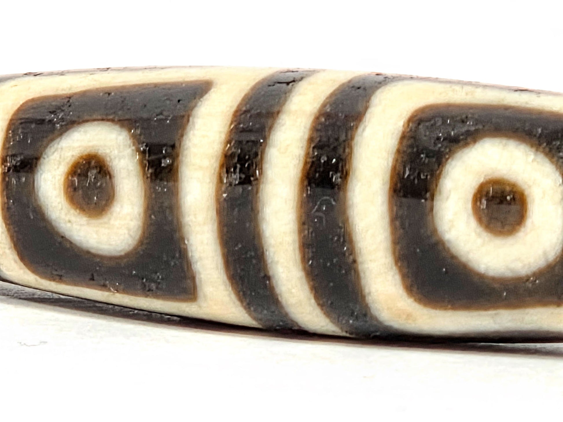 Ac-080425-4E macro Face A, both square-framed eyes full detail, surface pit between eyes disclosed, unretouched