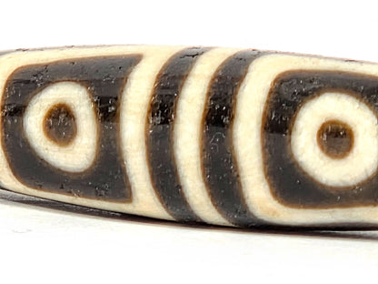 Ac-080425-4E macro Face A, both square-framed eyes full detail, surface pit between eyes disclosed, unretouched