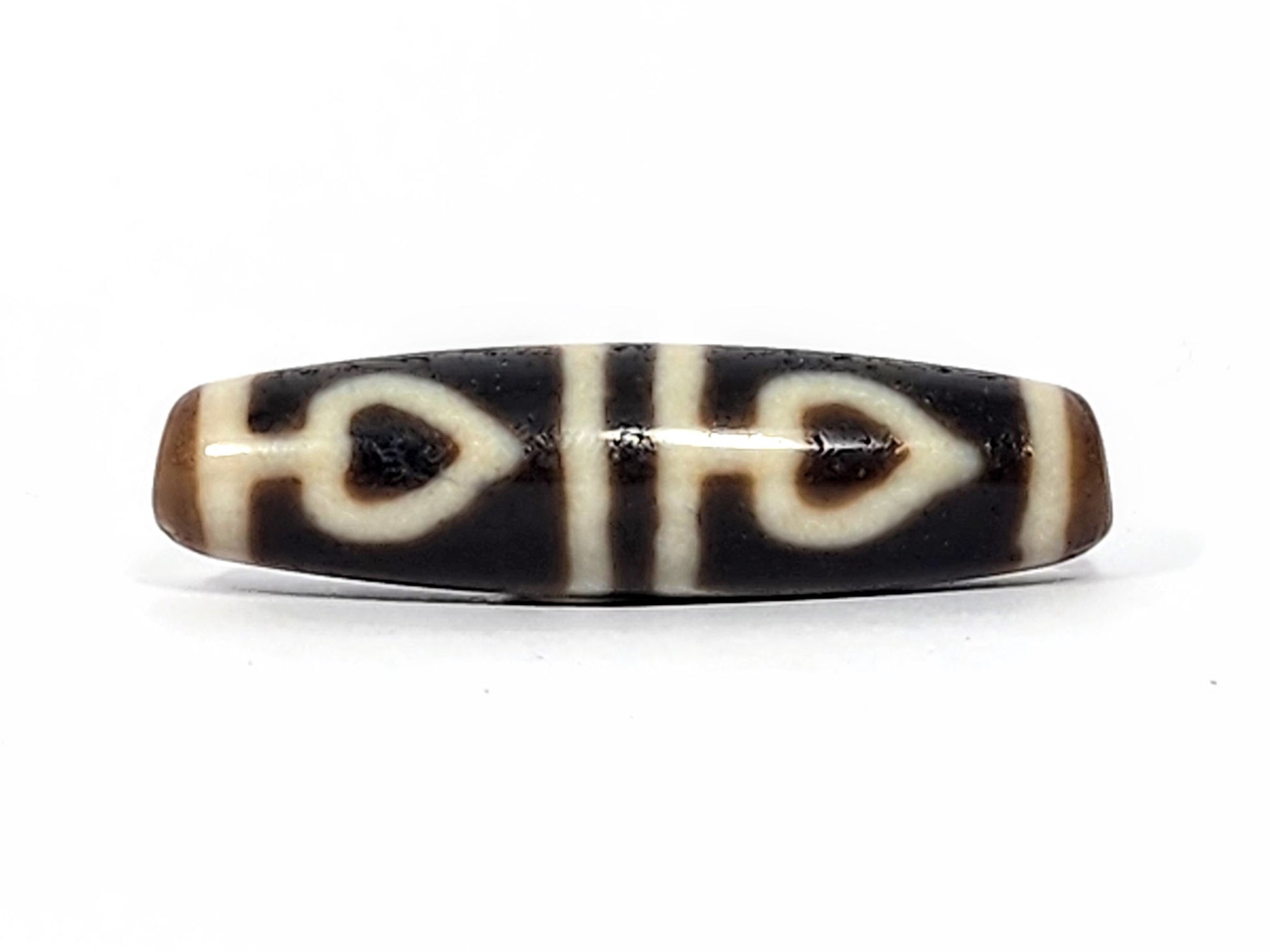 Ac-070625-FLB3 ancient four leaf bodhi dzi 47.6×12.6mm Face A, pitch-black ground bold cream-white leaves, unretouched