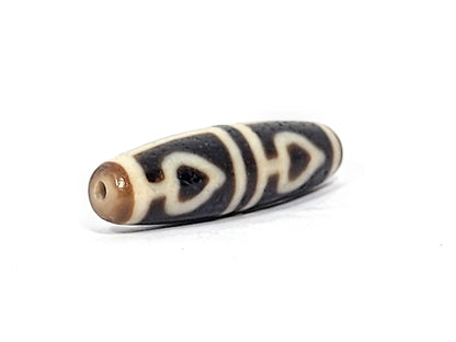 Ac-070625-FLB3 left drill hole end, sandy-tan tip and drill interior, bodhi leaf curves visible from end, unretouched