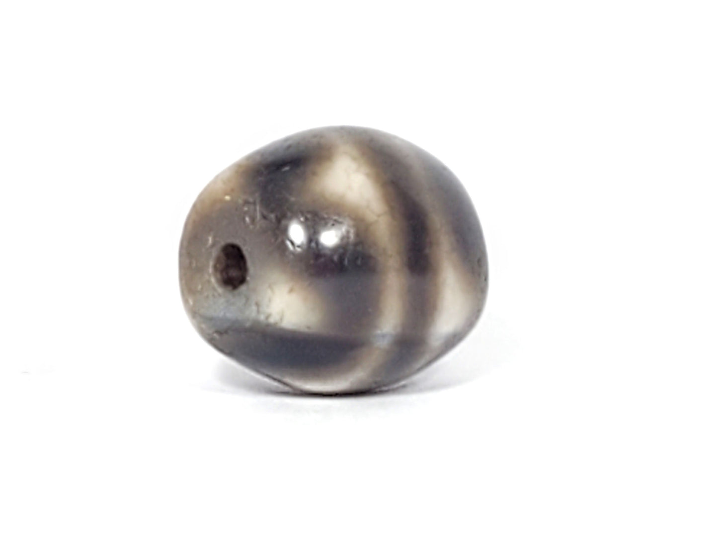 Ac-021724-TT ancient round tiger tooth dzi, sixth face view, drill hole side, unretouched