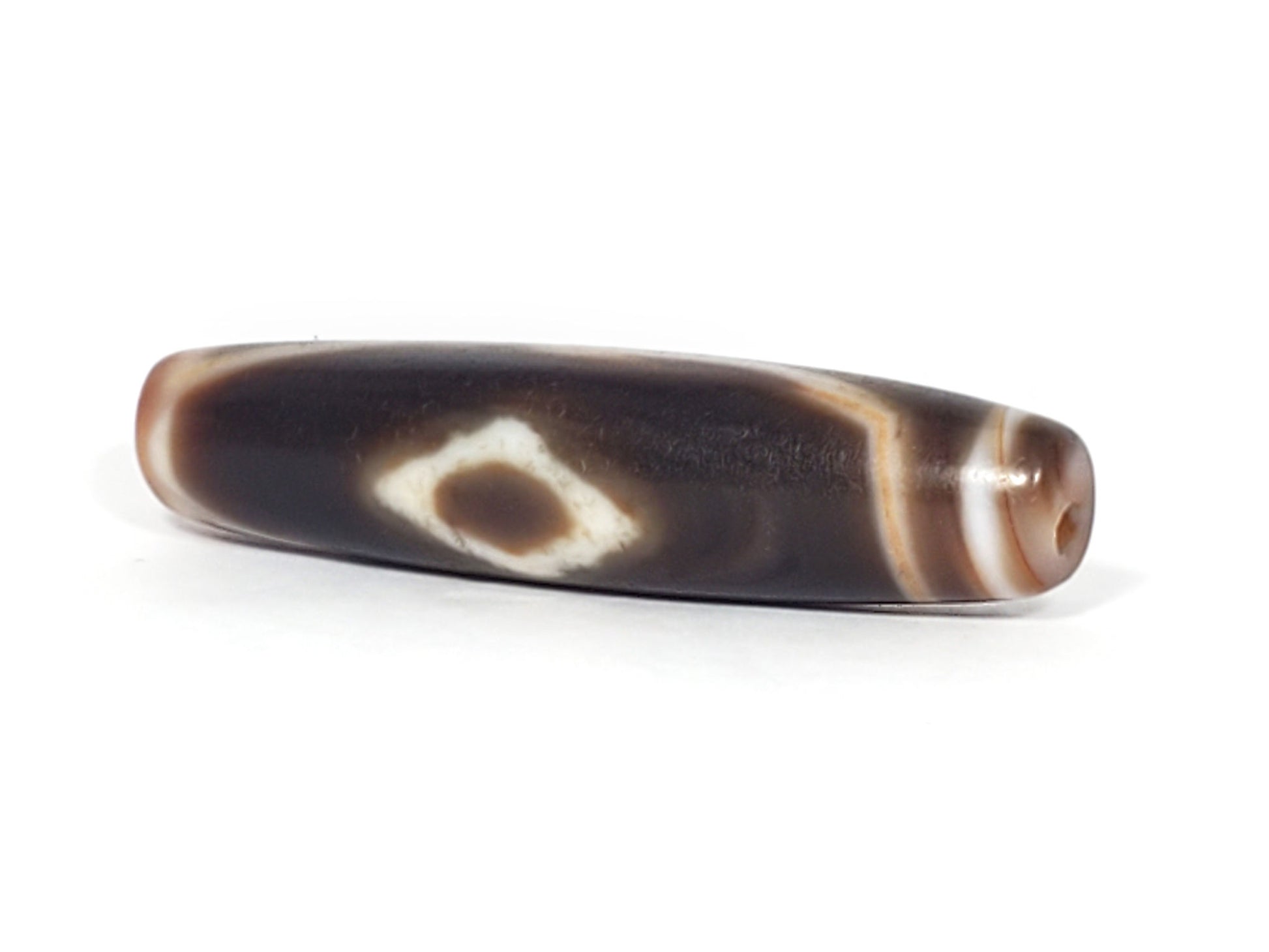 At-061926-3DE2 angled tip A, elongated fusiform form, warm reddish-brown end cap, unretouched