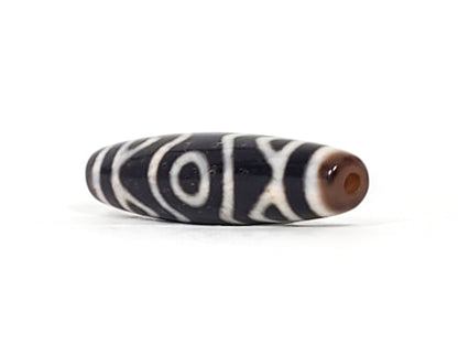 At-070926-3ETTBS antique three eye tiger tooth dzi angled view right drill end warm reddish-brown end cap unretouched