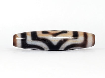 Rotated second face of antique Three Eye Dzi bead — bold white eye circles on deep black agate, 47.8mm, cinnabar bloodspot inclusions throughout