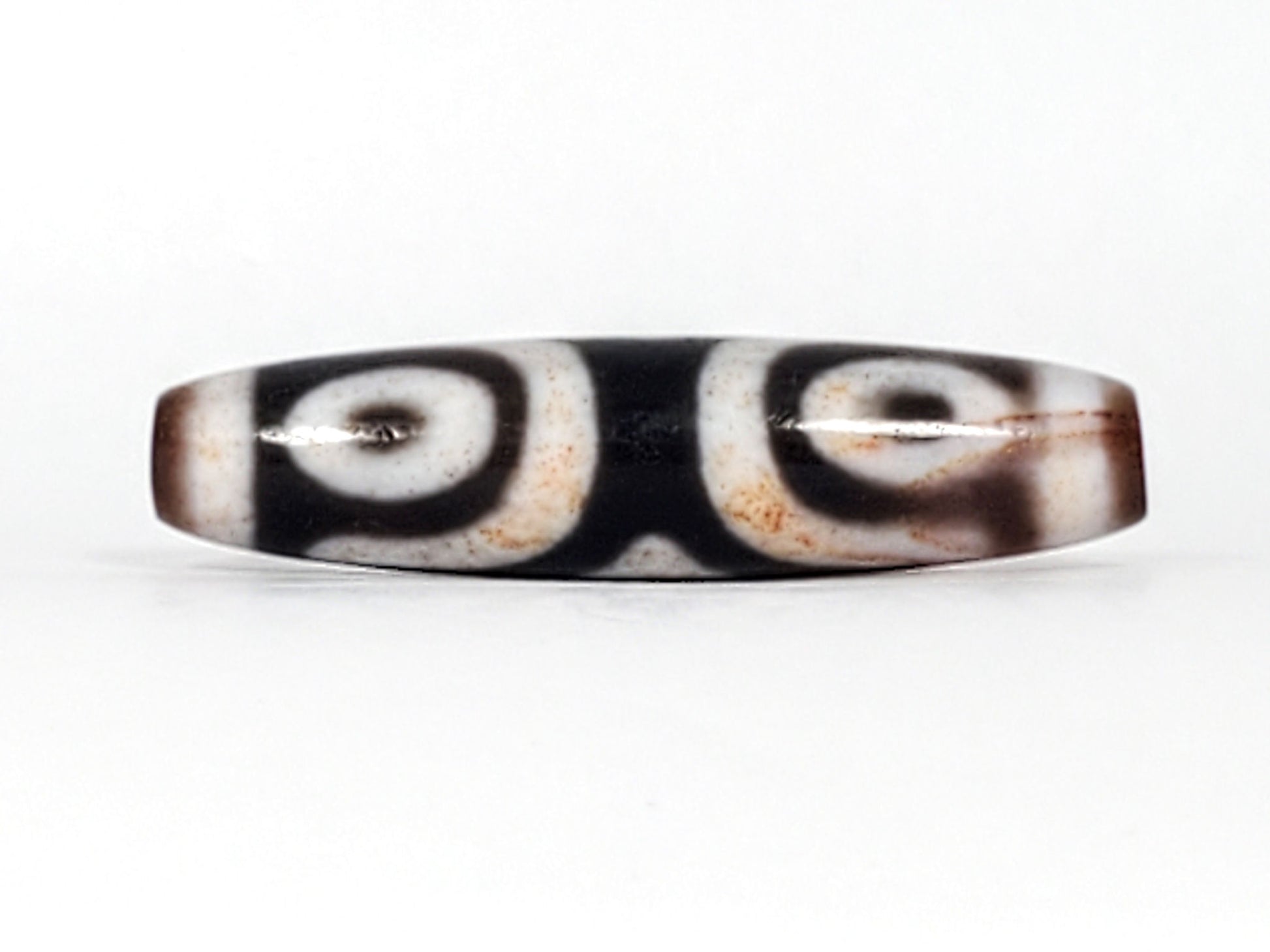 Third angle of antique Three Eye Dzi bead — all three eye circles visible across 47.8mm length, genuine Tibetan amulet, 100–200 years old