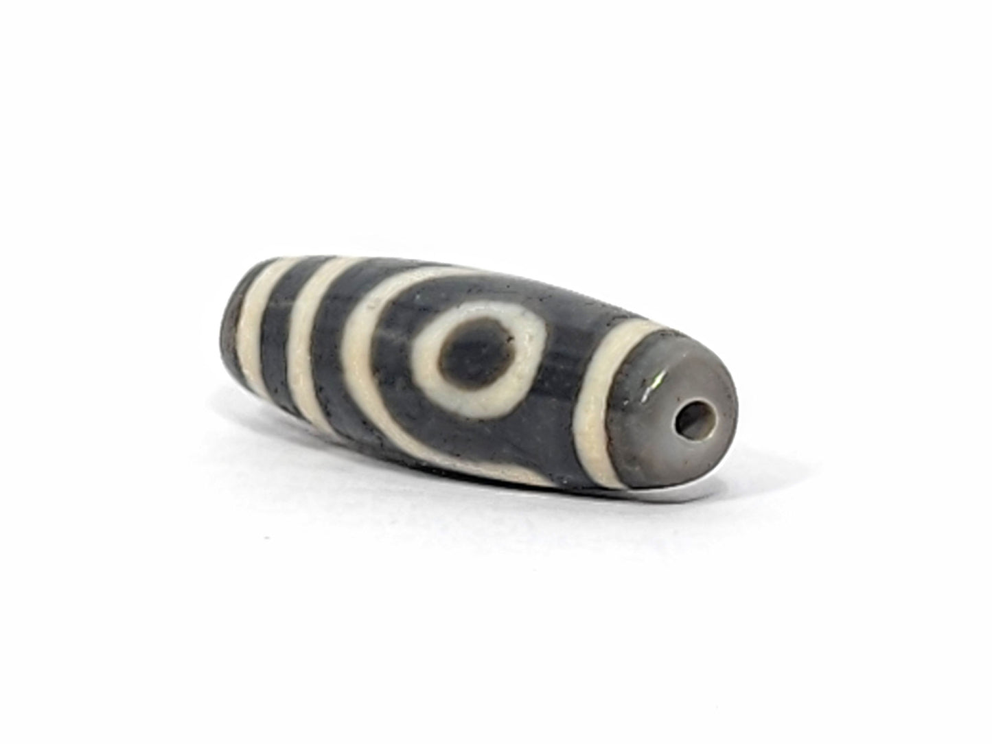 Ac-052525-2E right drill hole end, cool grey end cap and interior, spiral eye wrapping body, matte surface, unretouched
