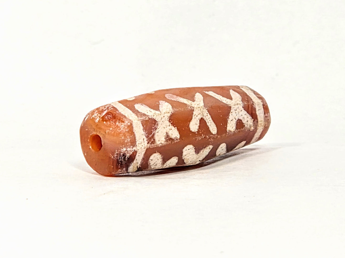 Ac-062426-12X ancient twelve X-cross carnelian dzi 28.5x11.0mm opposite end drill hole natural colour variation unretouched