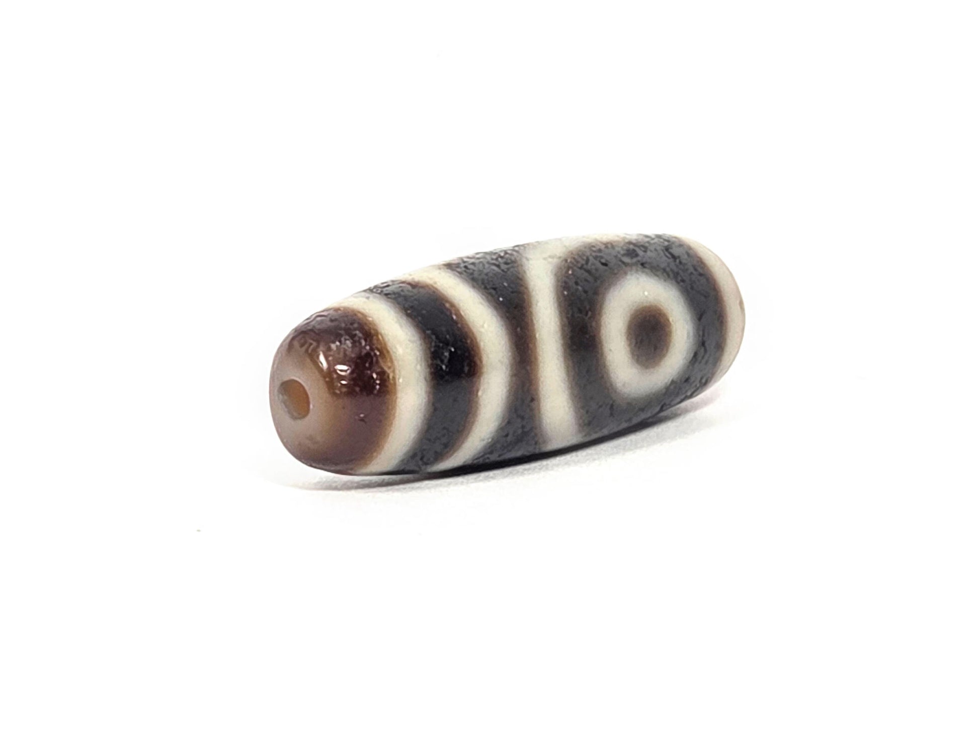 Ac-073026-2E ancient two eye dzi 35.8×11.8mm pitch-black agate angled view one eye stripe bands unretouched