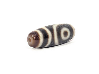 Ac-073026-2E ancient two eye dzi 35.8×11.8mm pitch-black agate angled view one eye stripe bands unretouched