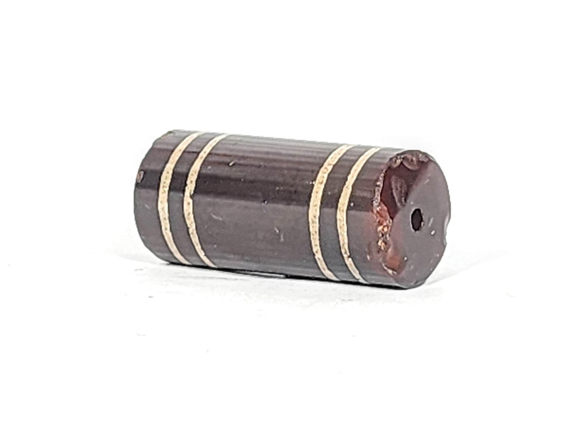 Ac-061426-4Str, right end showing extensive chip and reddish-brown interior exposed, drill hole intact, unretouched