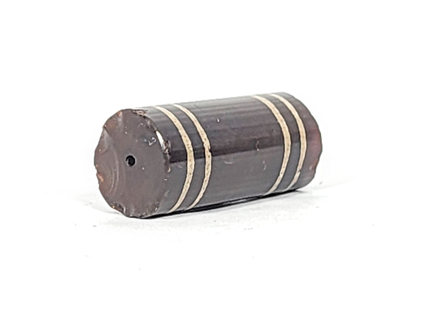 Ac-061426-4Str, left end showing moderate chip and fracture line, drill hole intact, deep grey-brown, unretouched