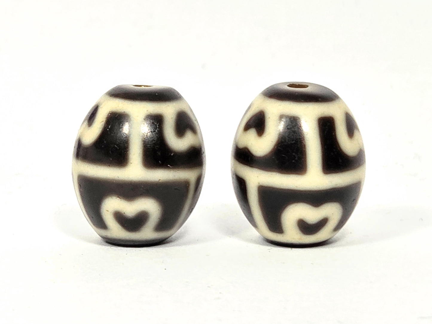 Close-up of weathering marks and waxy patina on 300-year-old Six-Eye Lotus Dzi beads.