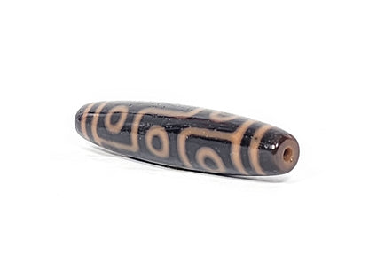 Antique nine eye dzi bead At-012325-9E4, front face, nine amber-orange eye rings on deep dark brown agate, full torpedo 59.0mm × 13.2mm, unretouched photography