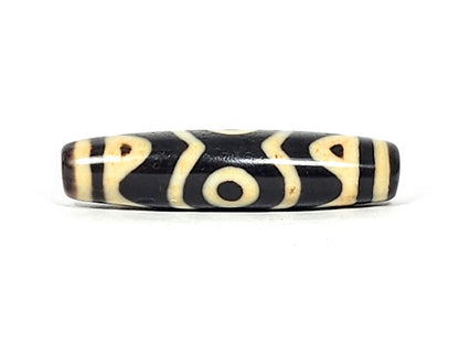 At-061926-3ETT Face C, third closed eye, open tiger tooth arcs, pitch-black ground, unretouched