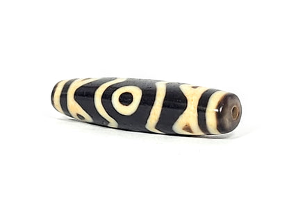 At-061926-3ETT angled tip B, elongated fusiform form, honey-brown end cap, drill hole, unretouched