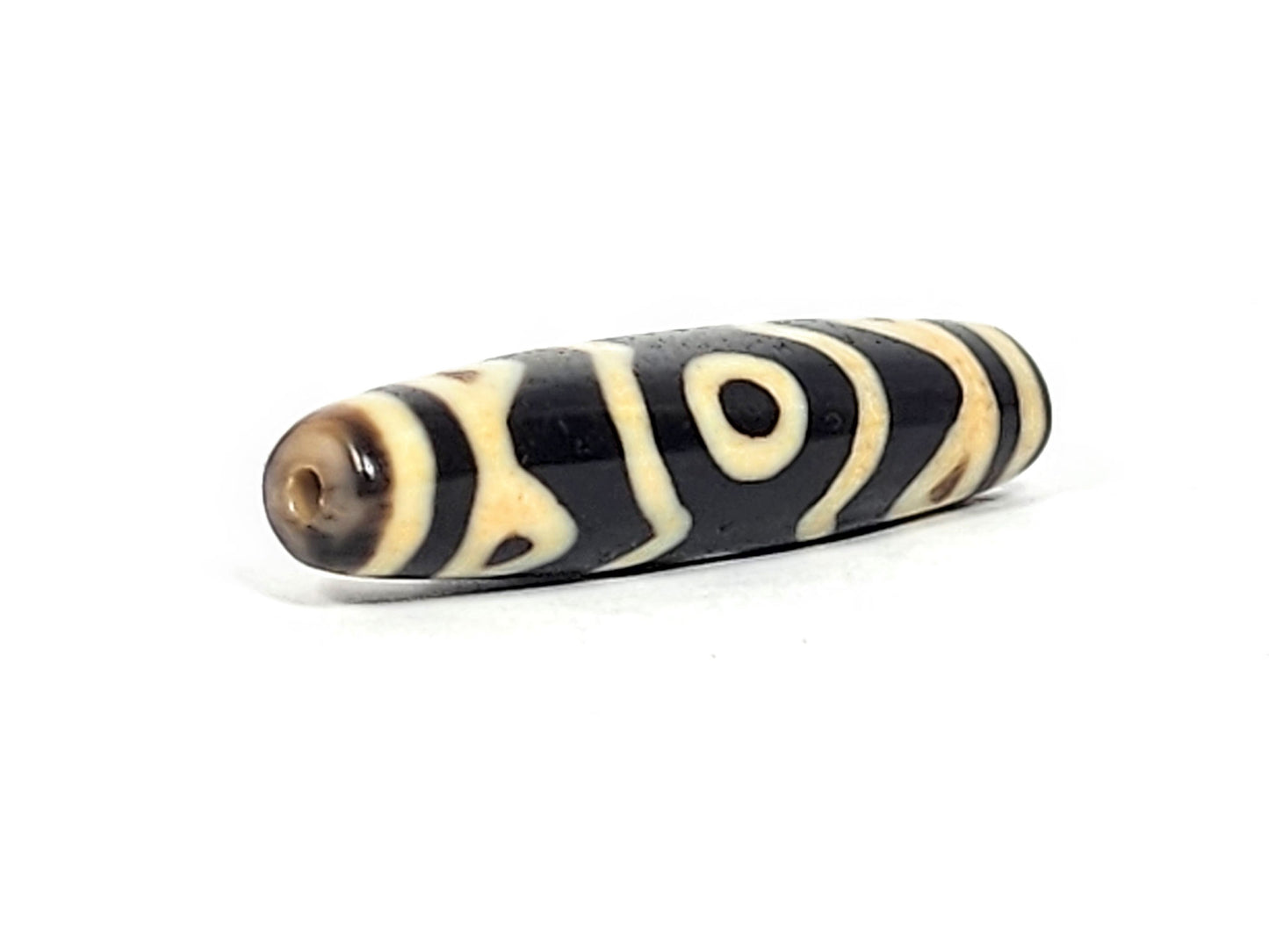 At-061926-3ETT angled tip A, warm dark brown end cap, clean drill hole, motif wrap visible, unretouched
