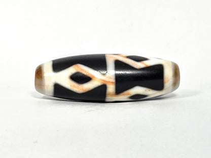 At-062126-6DE dzi bead, close side profile, golden-brown accent banding visible, unretouched