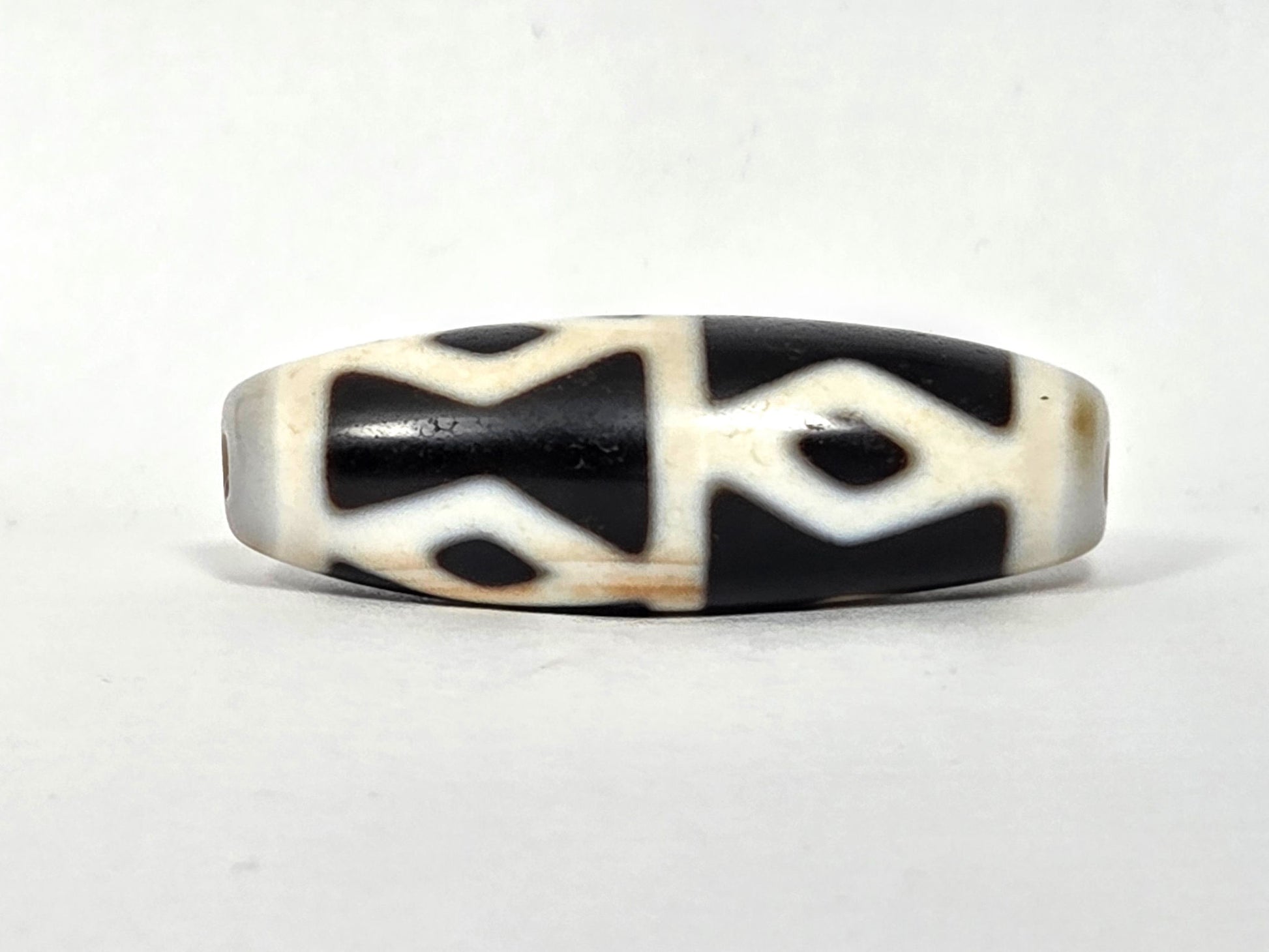 At-062126-6DE dzi bead, three-quarter angle, step-line divider detail, unretouched