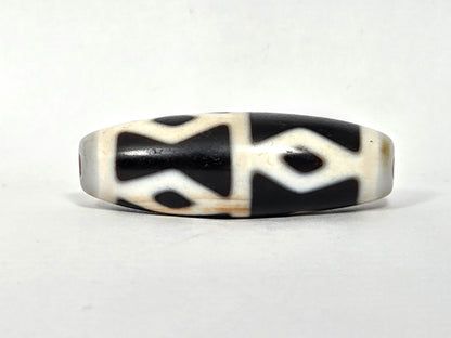 At-062126-6DE dzi bead, three-quarter angle, step-line divider detail, unretouched
