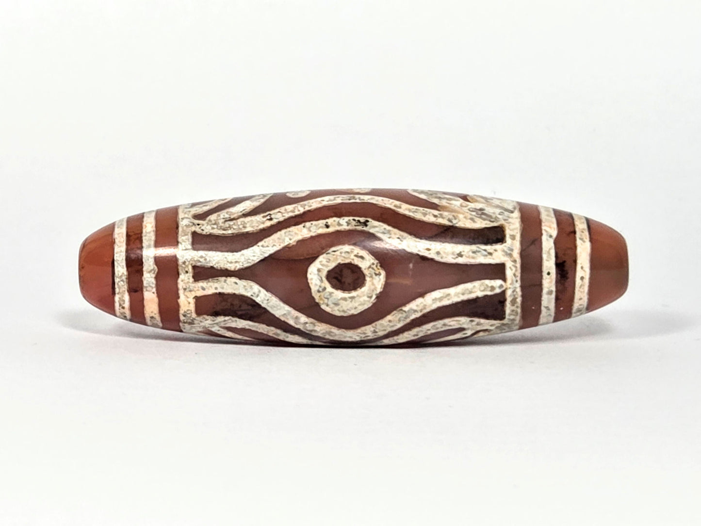 At-061426-2ETTSt carnelian dzi, Face C, second circular eye, open eye form, warm terracotta ground, unretouched