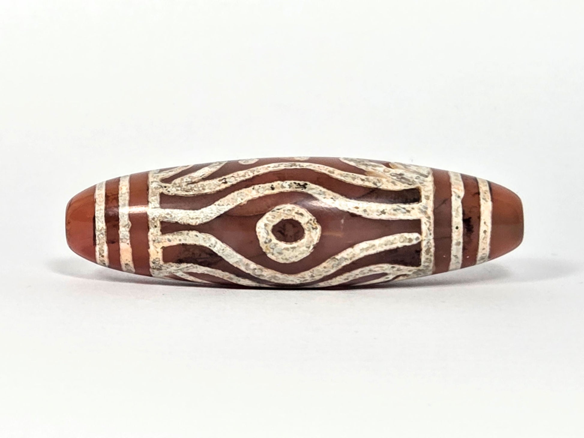 At-061426-2ETTSt carnelian dzi, Face C, second circular eye, open eye form, warm terracotta ground, unretouched