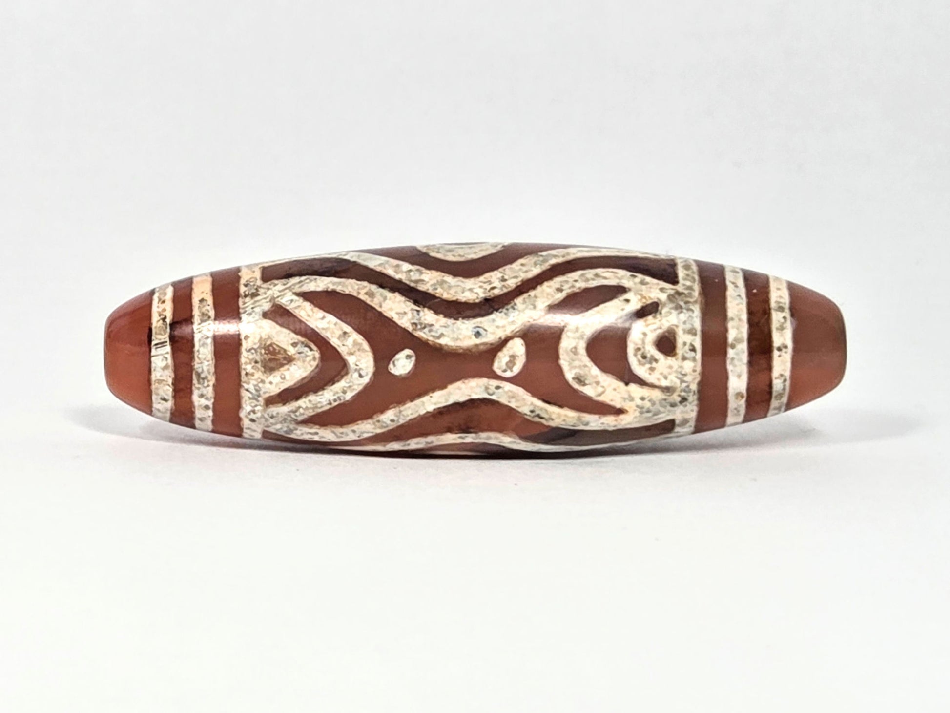 At-061426-2ETTSt carnelian dzi, Face D, hourglass-bowtie motif + star dots, cream-white etching, unretouched