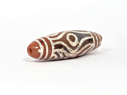 At-061426-2ETTSt carnelian dzi, intact left end cap, terracotta-red tip, clean drill hole, hairline disclosed, unretouched