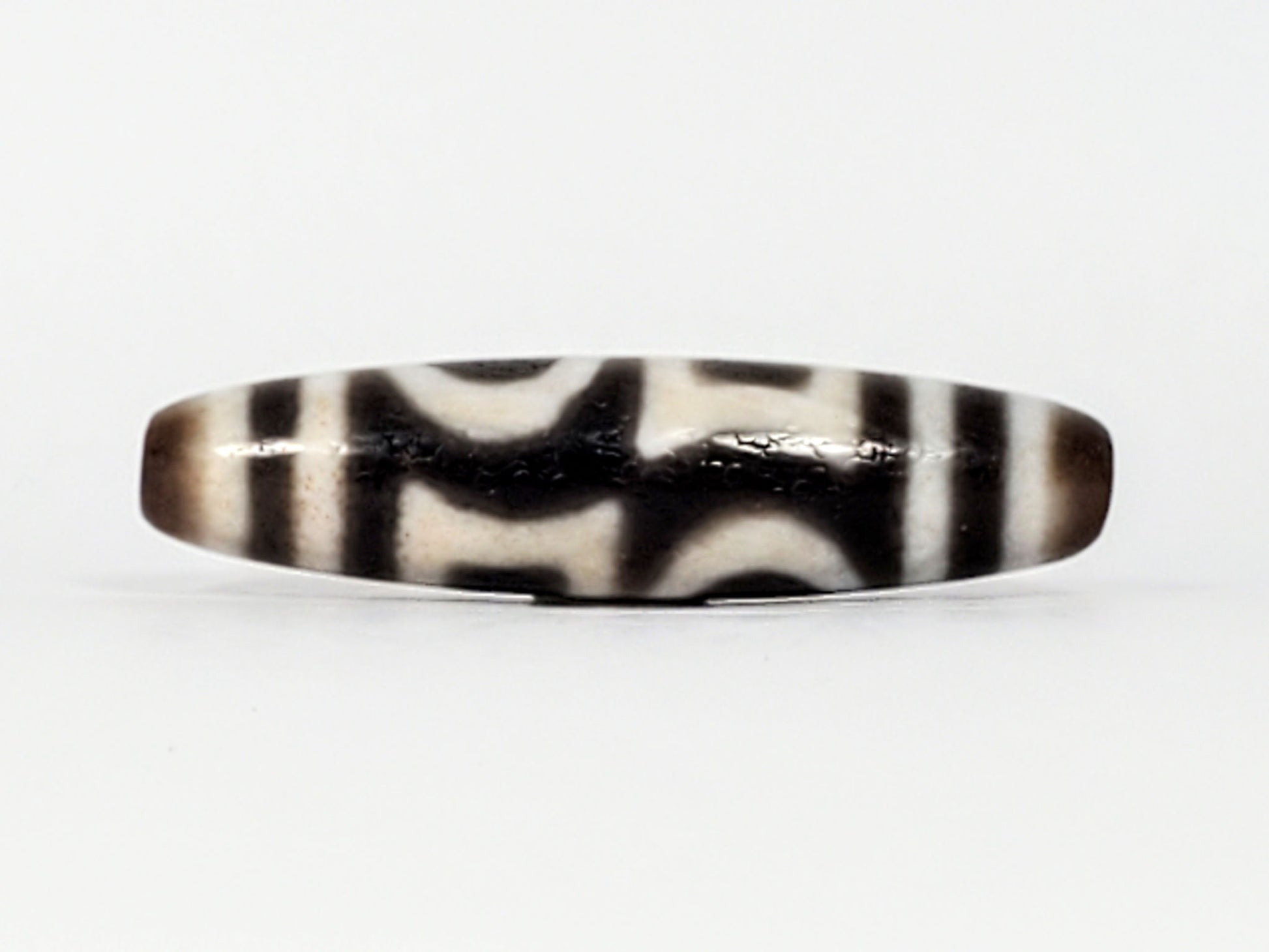 Second angle of antique Double Heaven & Earth Dzi — eye and Earth forms, cream on warm grey agate