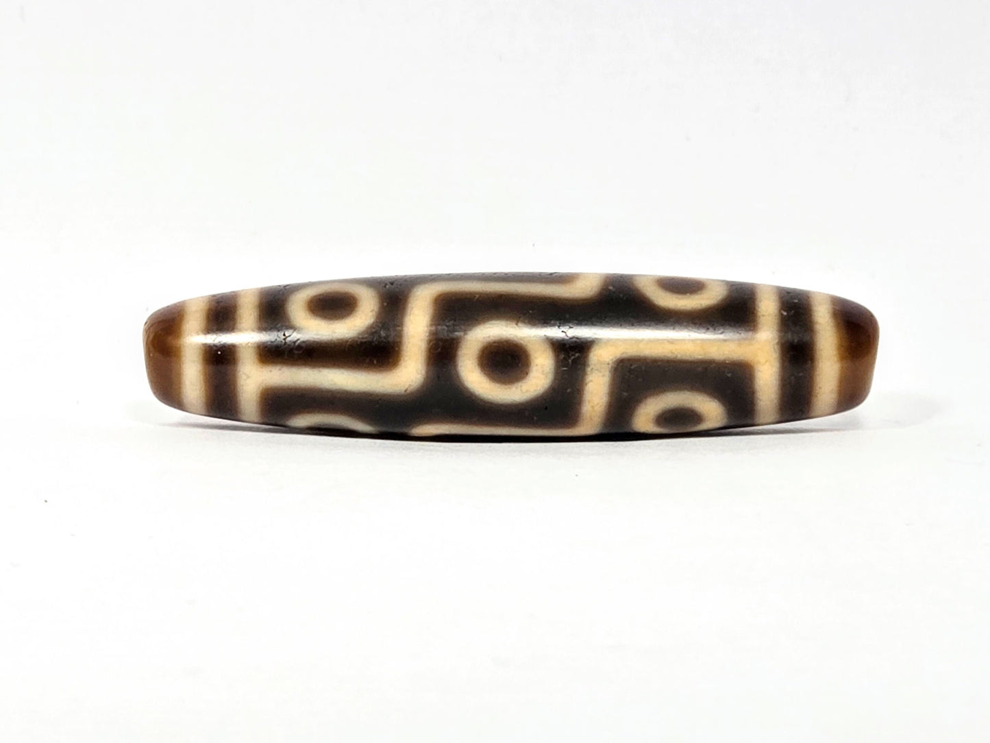 Antique Tibetan Nine Eye dzi bead face A, clean cream eye network on warm medium-brown agate, At-083025-9E3