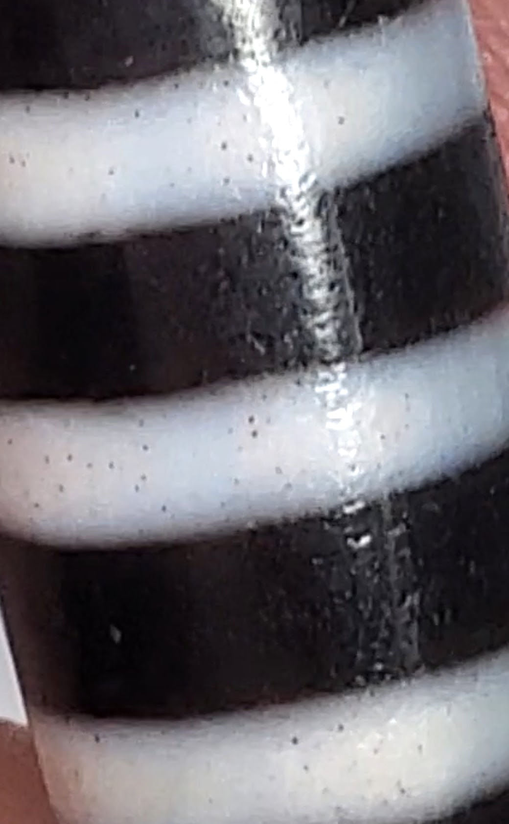 At-110223-9SBS, macro showing cinnabar micro-dots in stripe bands and surface score line on dark bands, unretouched