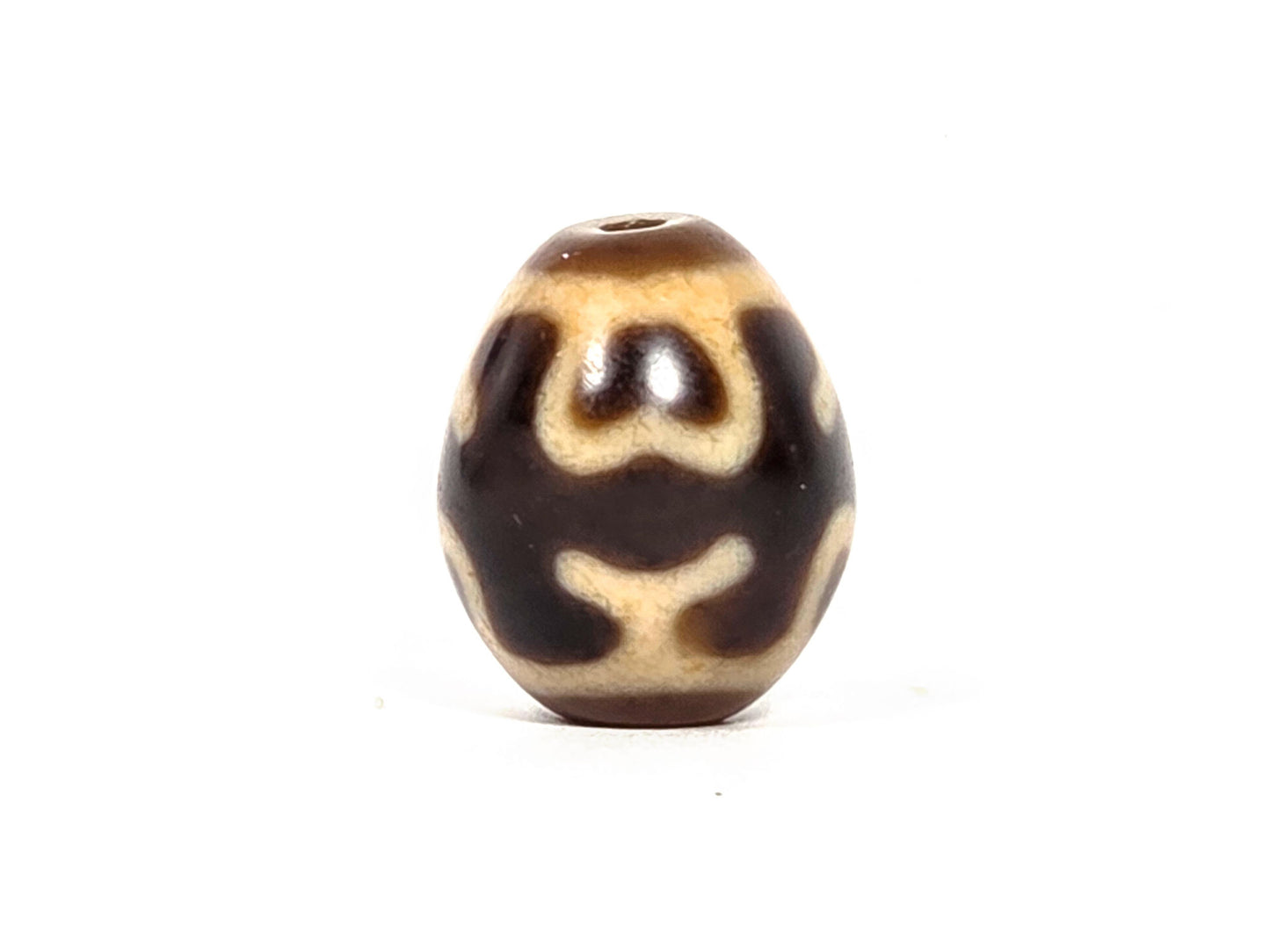 At-080926-4ELT antique round dzi bead 19.9×16.6mm, rotation B showing double-arch lotus petals upper zone and cream cross-bar element lower zone, unretouched