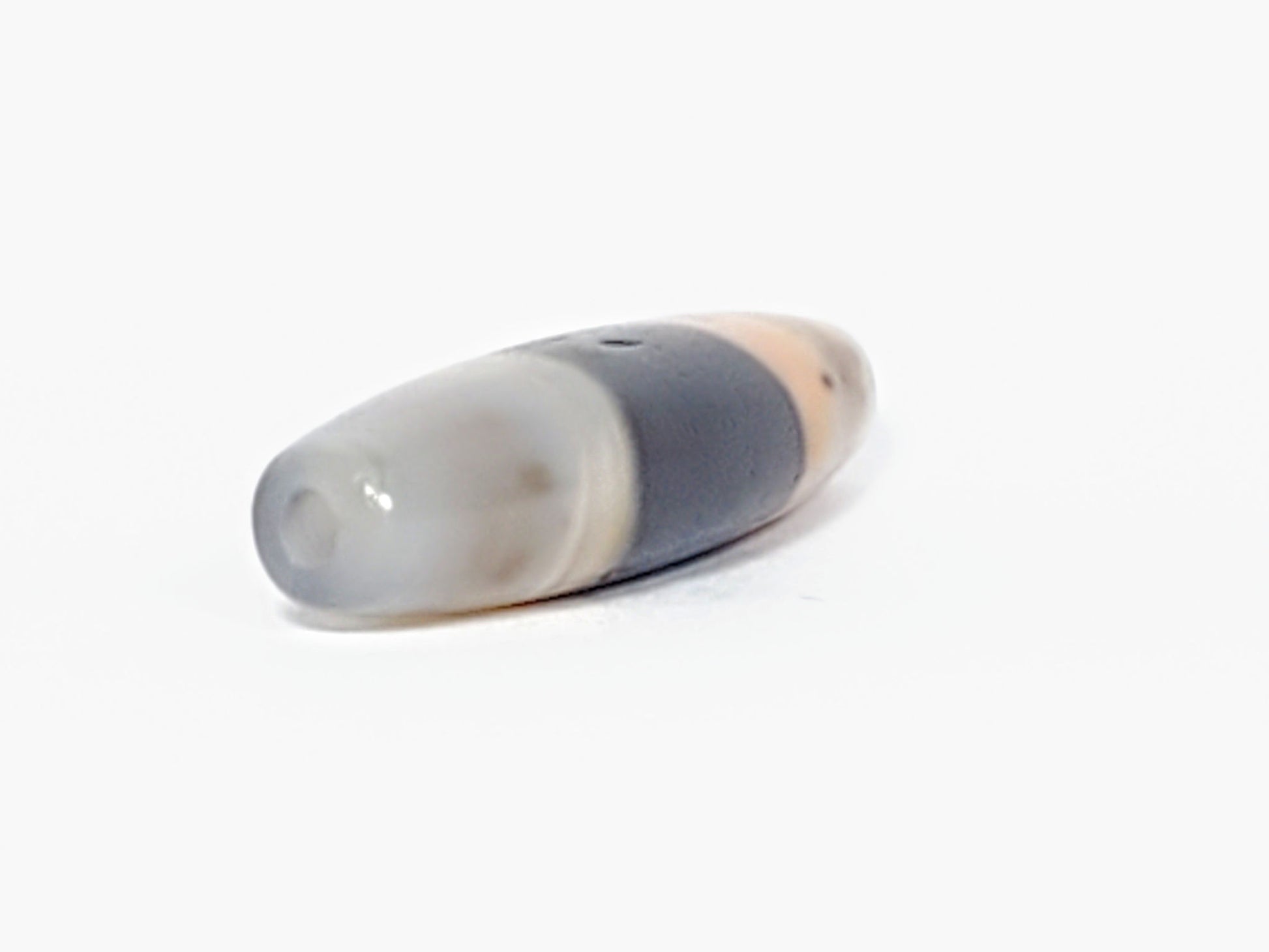 At-061526-1SBow, drill hole end cap face, milky grey-white agate, matte-satin finish, pinholes visible, unretouched