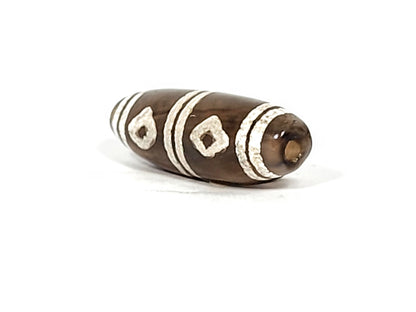 Antique six eye dzi — opposite end angled, drill hole at warm brown cap, two weathered diamond eyes visible, At-0426-6E