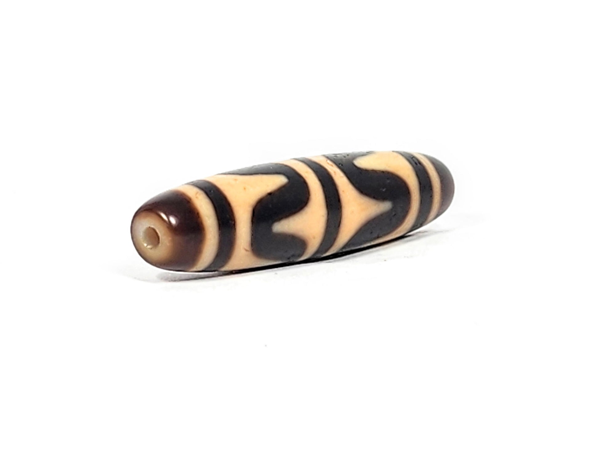 Opposite end of antique Tibetan Double Wave dzi bead showing brown agate cap and small drill hole, At-052526-DW3