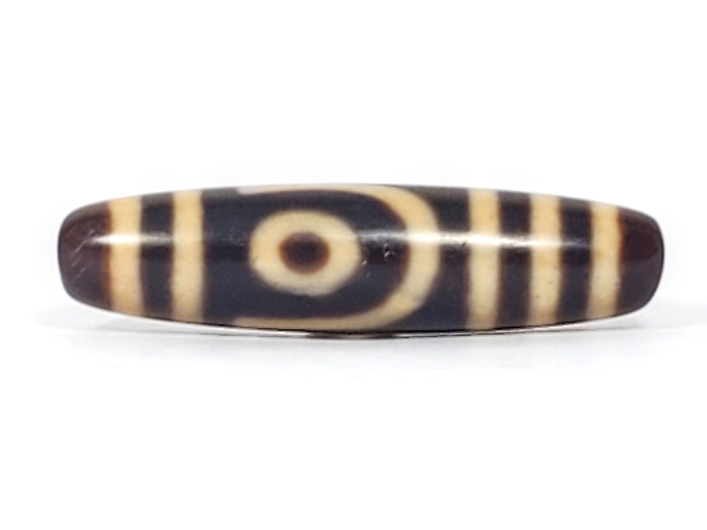 Antique Tibetan two eye dzi bead At-052526-2E2, front face showing open C-ring eye with cream concentric arcs on near-black agate ground, 47.4mm, unretouched photo