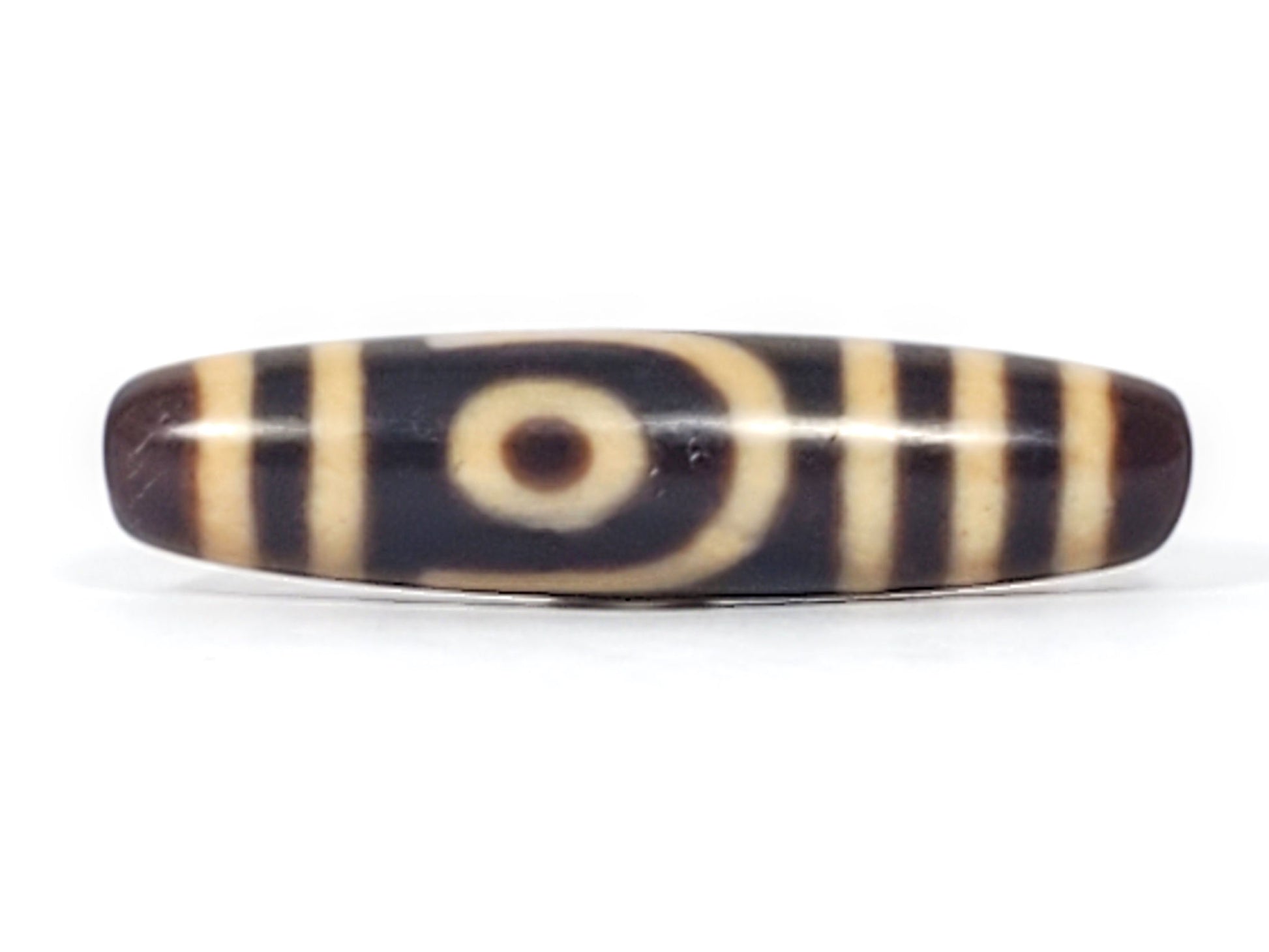 Antique Tibetan two eye dzi bead At-052526-2E2, front face showing open C-ring eye with cream concentric arcs on near-black agate ground, 47.4mm, unretouched photo