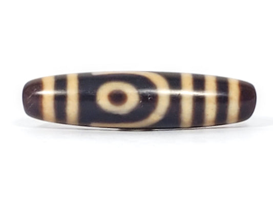 Antique Tibetan two eye dzi bead At-052526-2E2, front face showing open C-ring eye with cream concentric arcs on near-black agate ground, 47.4mm, unretouched photo