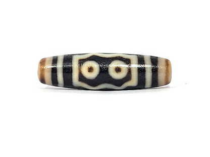 Antique five eye Kubera dzi At-072625-5E, Face A, two cream eye rings in notched rectangular frame on pitch-black agate, 44.5mm × 12.4mm, unretouched photography
