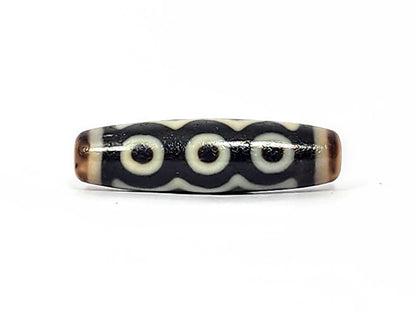 Face C of antique five eye dzi At-072625-5E, three cream eye rings linked by continuous arc on pitch-black agate, colonnade composition, 44.5mm, unretouched photography