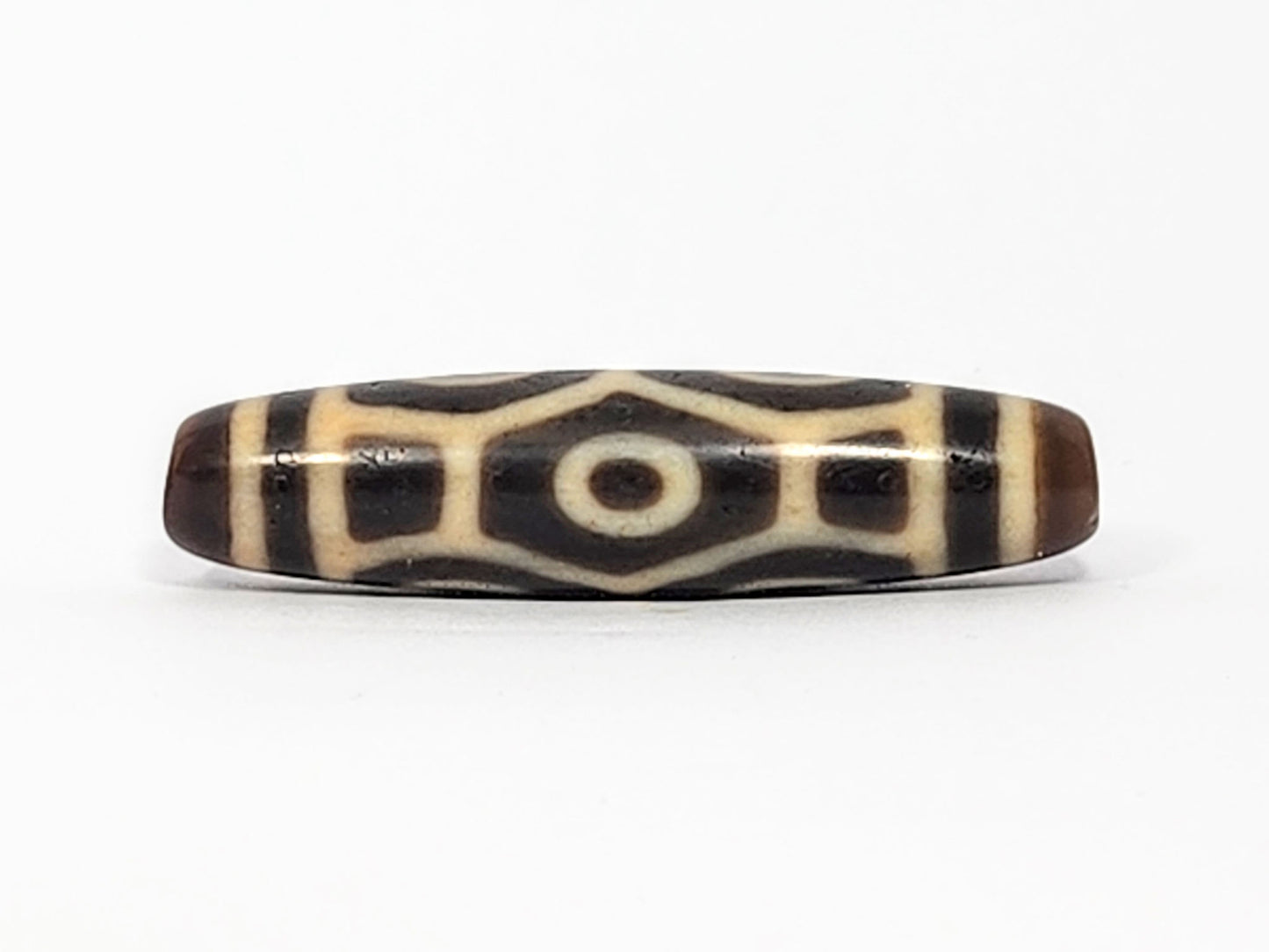 Antique Tibetan Naga dzi bead face D showing hexagonal body scale with squared rectangular dark panels, At-050725-6EN3