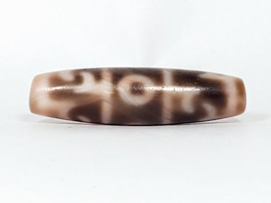 At-060326-GRRP, antique Guru Rinpoche paraphernalia dzi, 44.5×12mm, cream ground, chocolate-brown motif, unretouched