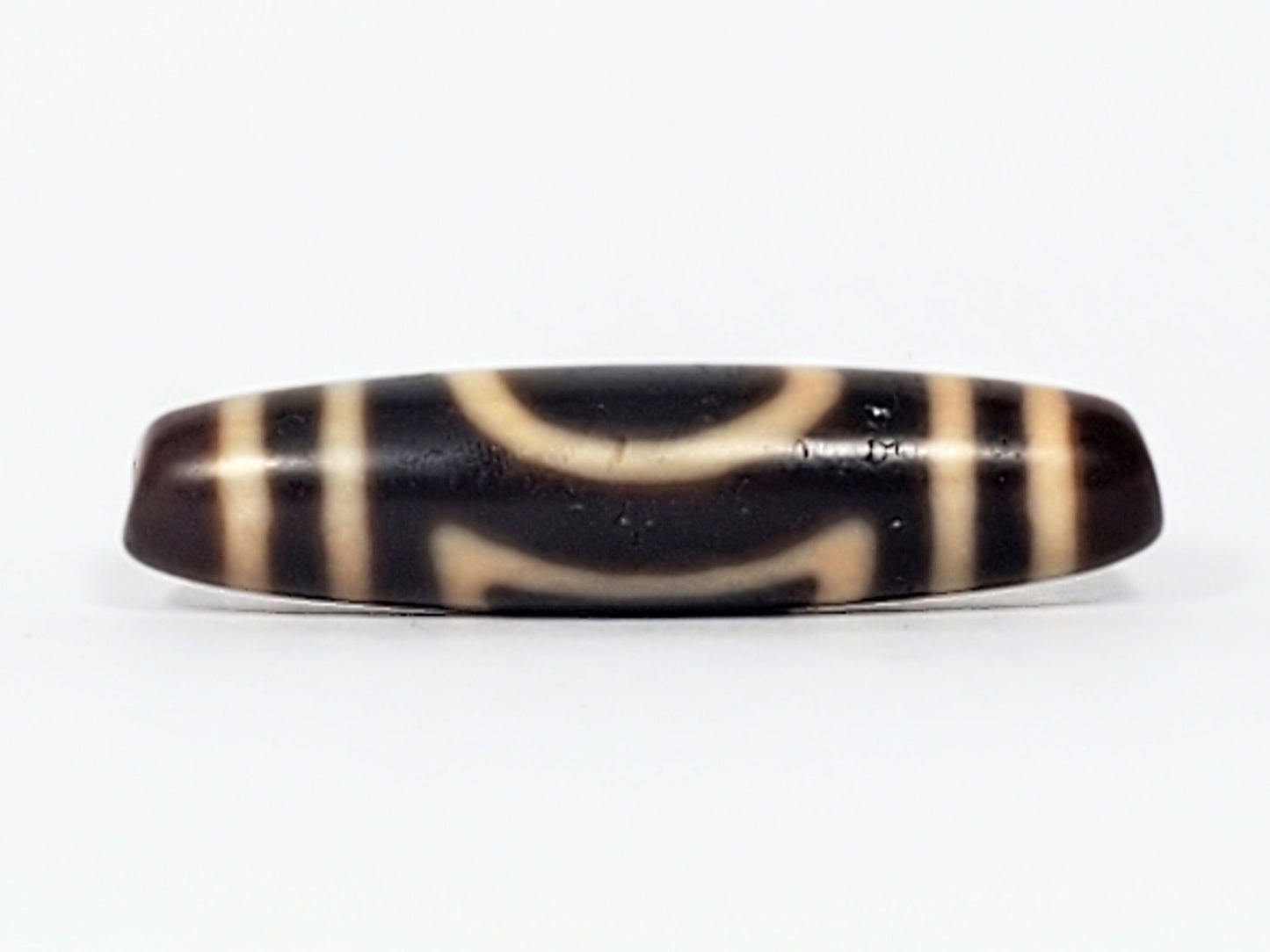 Antique Heaven Earth dzi bead face B showing upper arch and lower bracket forms on near-black agate, At-082324-HE3