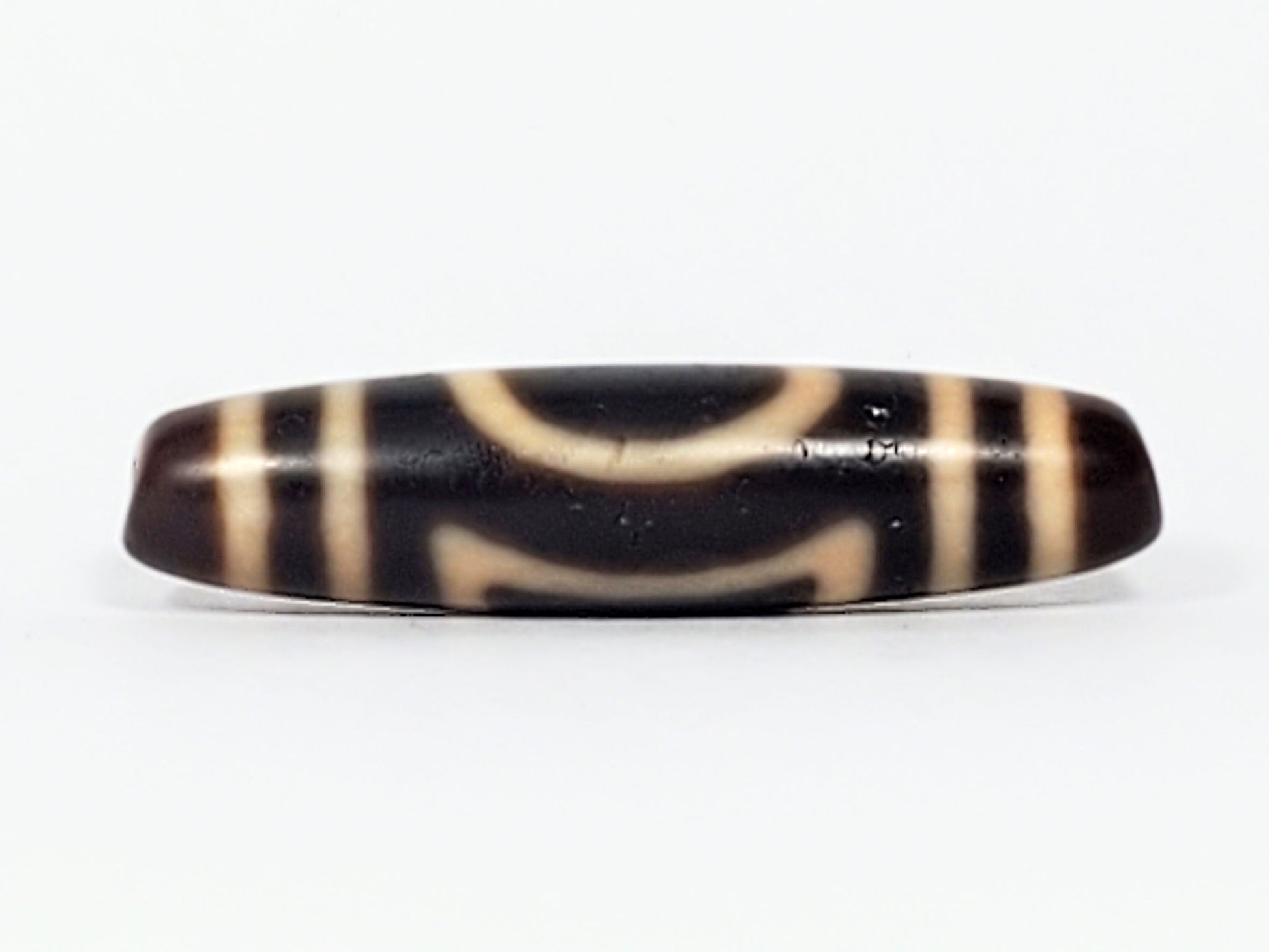 Antique Heaven Earth dzi bead face B showing upper arch and lower bracket forms on near-black agate, At-082324-HE3
