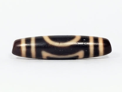 Antique Heaven Earth dzi bead face B showing upper arch and lower bracket forms on near-black agate, At-082324-HE3