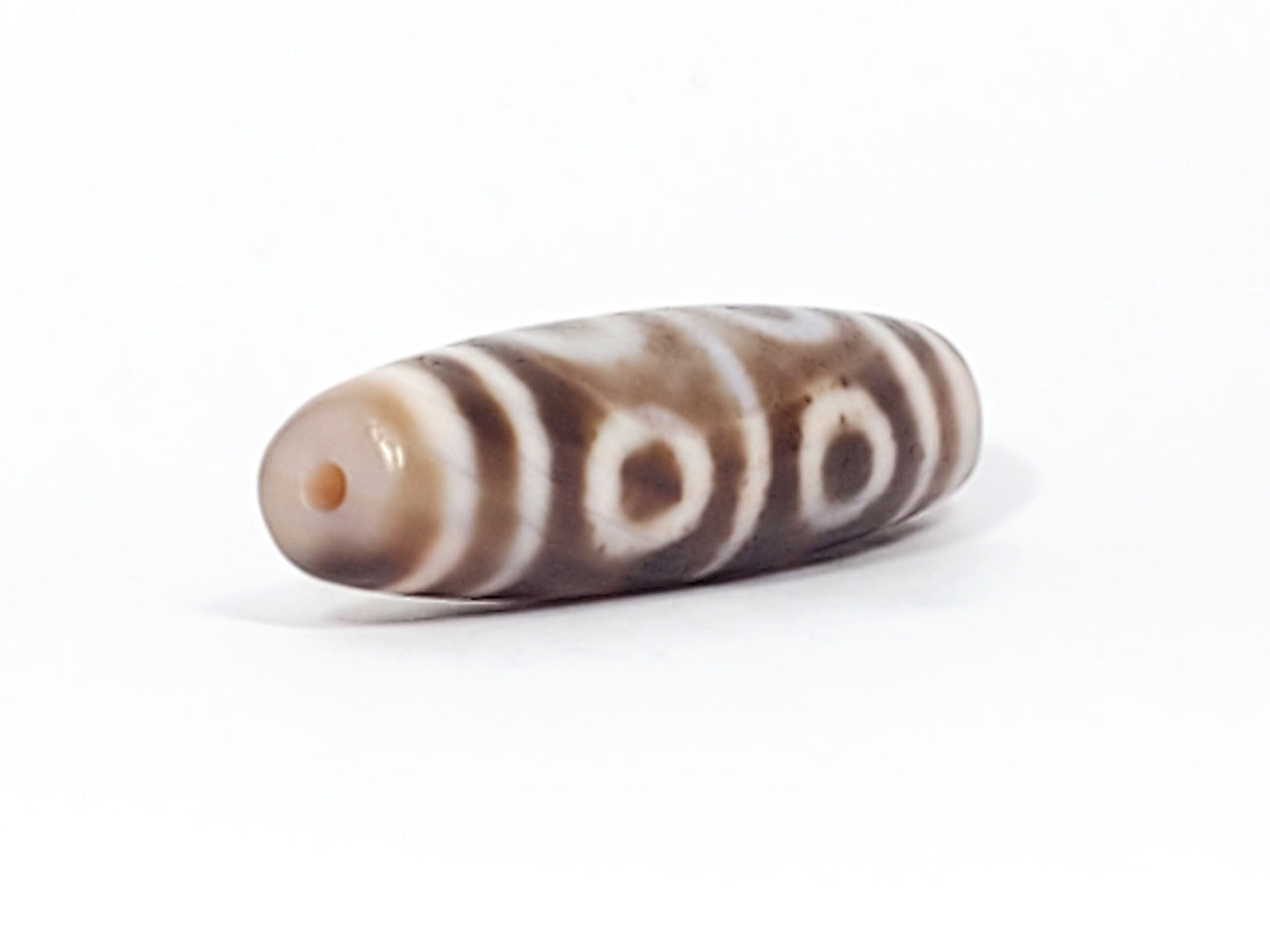 At-081624-8E end A sandy-beige cap wide tablet-barrel form open-ring eyes dzi unretouched