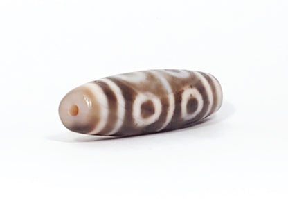 At-081624-8E end A sandy-beige cap wide tablet-barrel form open-ring eyes dzi unretouched